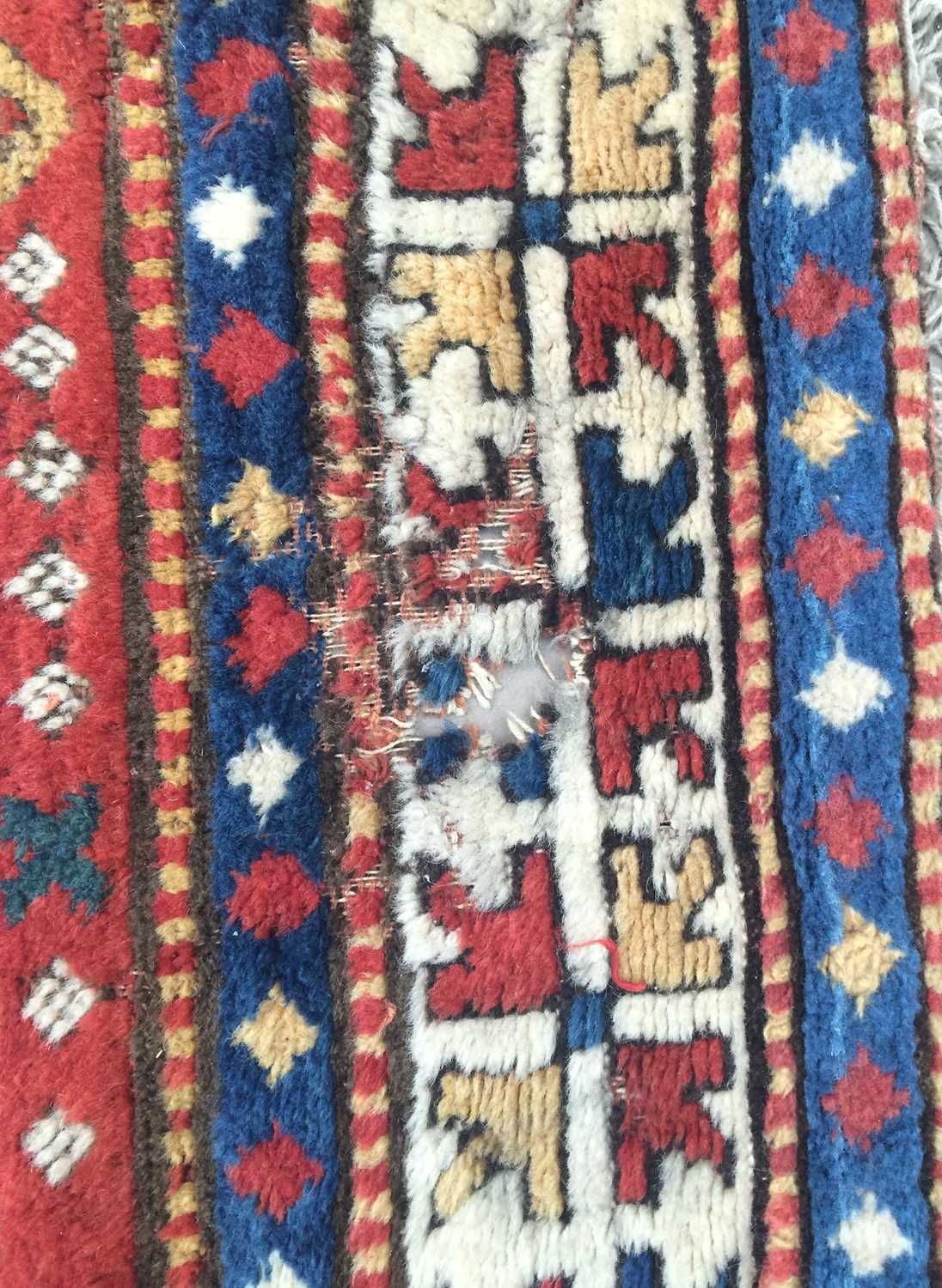 ~ Sewan Kazak Rug South Caucasus, circa 1880 The abrashed tomato red field with typical shield/ - Image 6 of 9
