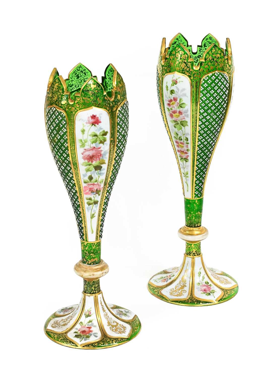 A Pair of Bohemian White-Overlay Green Glass Vases, of slender tulip form, painted with flowering