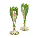 A Pair of Bohemian White-Overlay Green Glass Vases, of slender tulip form, painted with flowering