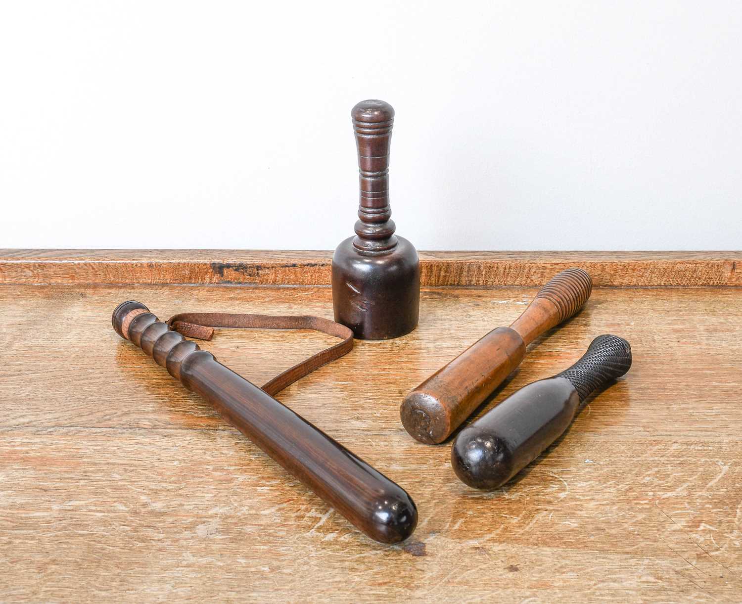 A Victorian Turned Hardwood Truncheon, mid 19th century, weighted and with leather strap 39cm long A