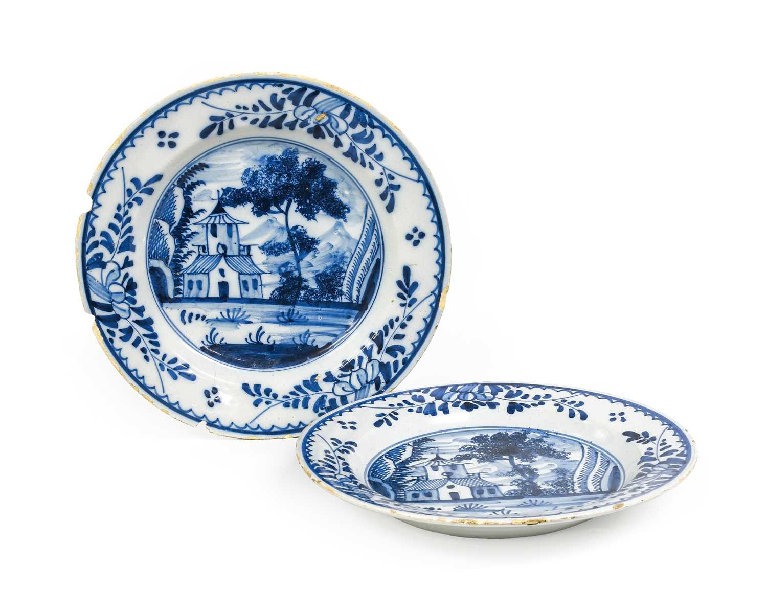 A Pair of English Delft Plates, circa 1750, painted in blue with landscape roundels each with a