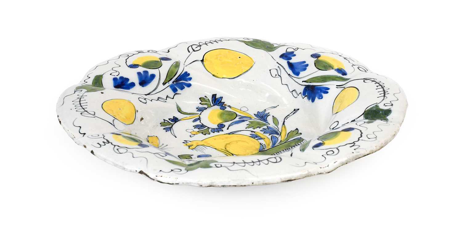 A Dutch Delft Lobed Dish or "Buckelplatte", early 18th century, painted in colours with a seated cat - Image 2 of 2