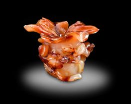 A Chinese Carnelian Agate Vase, Qing Dynasty, 19th/20th century, in the form of a peony flower