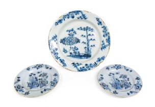 An English Delft Charger, 18th century, painted in blue with a large peony bloom beside bamboo