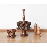 A Fruitwood Treen Egg Stand and Six Cups, early 19th century, with globular knop, turned carrying