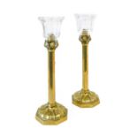 A Pair of Brass Spring-Loaded Candlesticks, late 19th century, the panelled cut glass urn-shaped