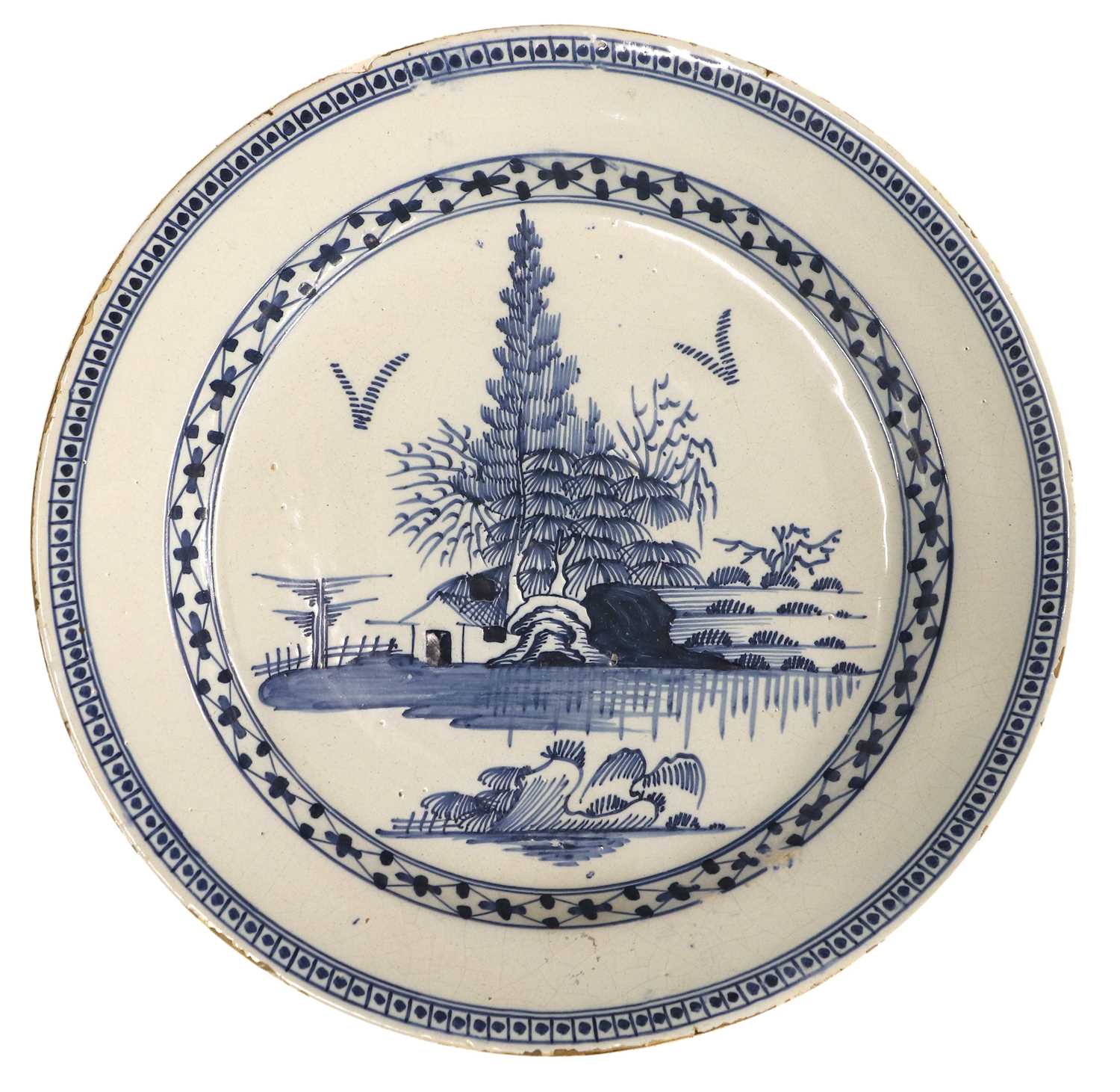 An English Delft Charger, circa 1760, painted in blue with a chinoiserie landscape within a