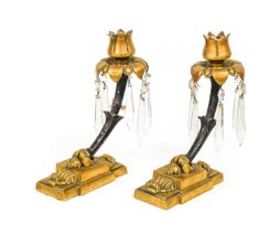 A Pair of Gilt and Patinated Bronze Lustre Candlesticks, with foliate sockets and drip pans hung