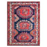 ~ Good Kazak Rug North West Iran, circa 1920 The indigo field with three Turkmen güls enclosed by