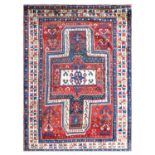 ~ Sewan Kazak Rug South Caucasus, circa 1880 The abrashed tomato red field with typical shield/