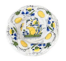 A Dutch Delft Lobed Dish or "Buckelplatte", early 18th century, painted in colours with a seated cat