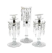 A Pair of Cut Glass Table Lustres, in Regency style, the urn-shaped sconces on circular drip pans