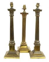 A Pair of Gilt Metal Table Lamps, in the form of corinthian columns, on stepped square bases,