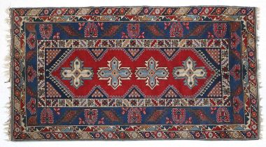 Dosemealti Rug West Anatolia, circa 1970 The crimson field with four ice blue and ivory cruciform