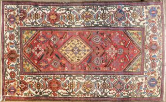 Rare North West Persian Rug, circa 1920 The raspberry field of tribal and zoomorphic motifs around a