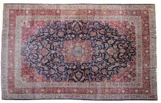 Kashan Carpet Central Iran, circa 1940 The indigo field with raspberry and pale blue central