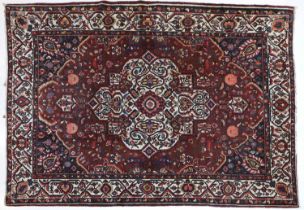 Bakhtiari Carpet West Iran, circa 1930 The chestnut brown field of angular vines and polychrome