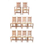 A Set of Ten (8+2) Arts & Crafts Oak Dining Chairs, made by William Birch, each with arched top rail