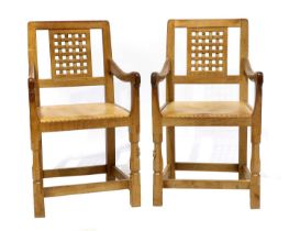 Workshop of Robert Mouseman Thompson (Kilburn): Two English Oak Lattice Back Arm Chairs, 1978, tan