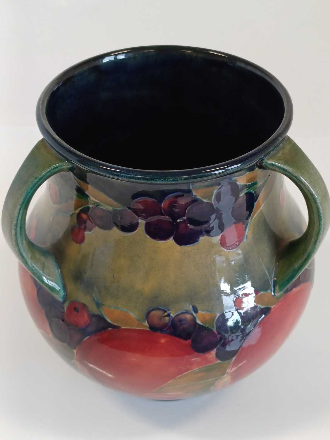 William Moorcroft (1872-1945): A Pomegranate Pattern Three-Handled Vase, on a green/blue ground, - Image 4 of 13