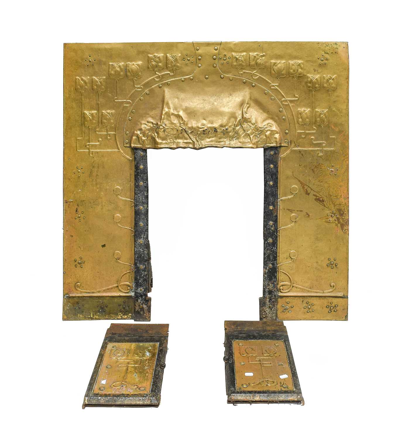 An Art Nouveau Brass Hooded Fire Surround, circa 1900, repoussé decorated with stylised tulips and