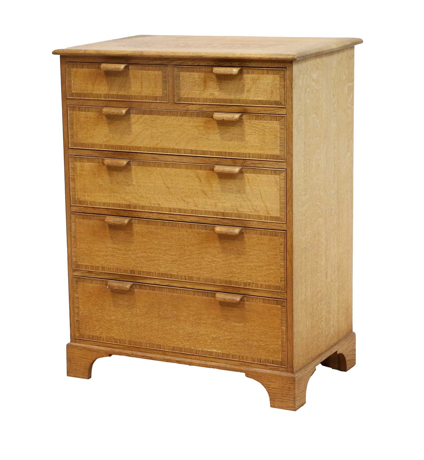 An English Oak Crossbanded Chest of Drawers, the rectangular top above two short over four