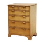 An English Oak Crossbanded Chest of Drawers, the rectangular top above two short over four