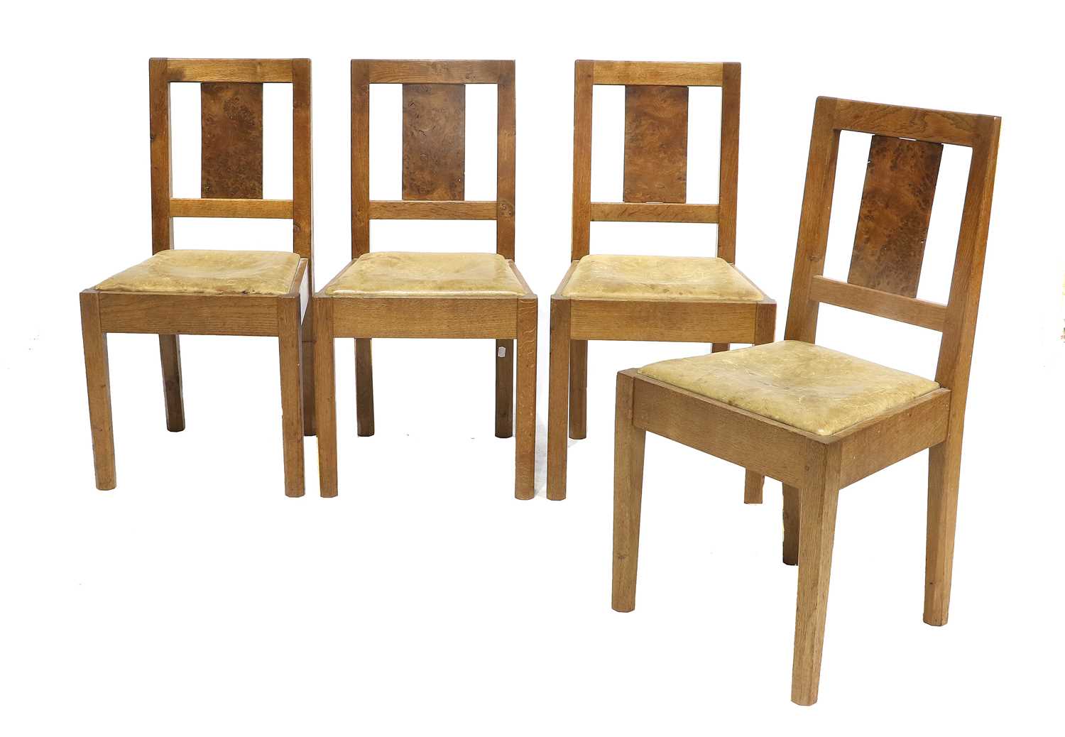 A Set of Four English Oak Dining Chairs, each with burr oak slat back panels, leather hide