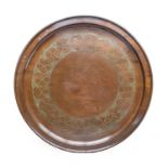 Ernest Harrison: An Arts & Crafts Circular Copper Charger, repoussé decorated with a border of