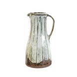 Jim Malone (b.1946): A Tall Stoneware Faceted Jug, nuka ash glaze, impressed JM and Ainstable