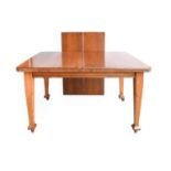An Arts & Crafts Oak Extending Dining Table, rectangular top with moulded edge, on four tapering