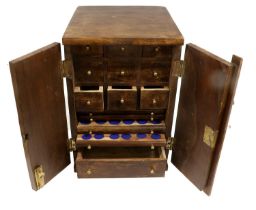 A Hardwood Collectors Cabinet, comprising, 9x storage drawers, 5x coin trays with recesses of two