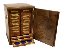 A Coin Collectors Cabinet, intended for crowns and double florins, in walnut with 24x trays with (