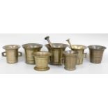 Seven 17th Century and Later Bronze Mortars, each with banded decoration, with two pestles,