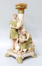 A Royal Dux Porcelain Figural Vase, formed as a classical column and with two Grecian figures
