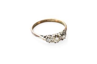 A Diamond Three Stone Ring, the graduated round brilliant cut diamonds in white claw settings, to