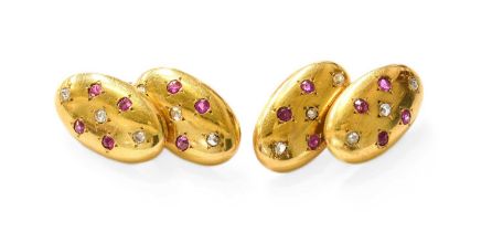 A Pair of Ruby and Diamond Cufflinks, the chain linked oval plaques inset with round cut rubies