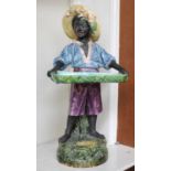 A Continental Fience Figural Vase, circa 1900, modelled as a boy carrying a tray on naturalistic