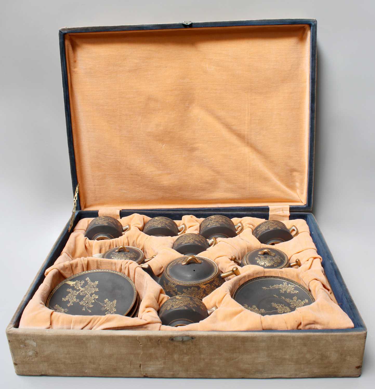 A Cased Japanese Satsuma Earthenware Tea Service, Taisho period, in fitted case, matt black ground
