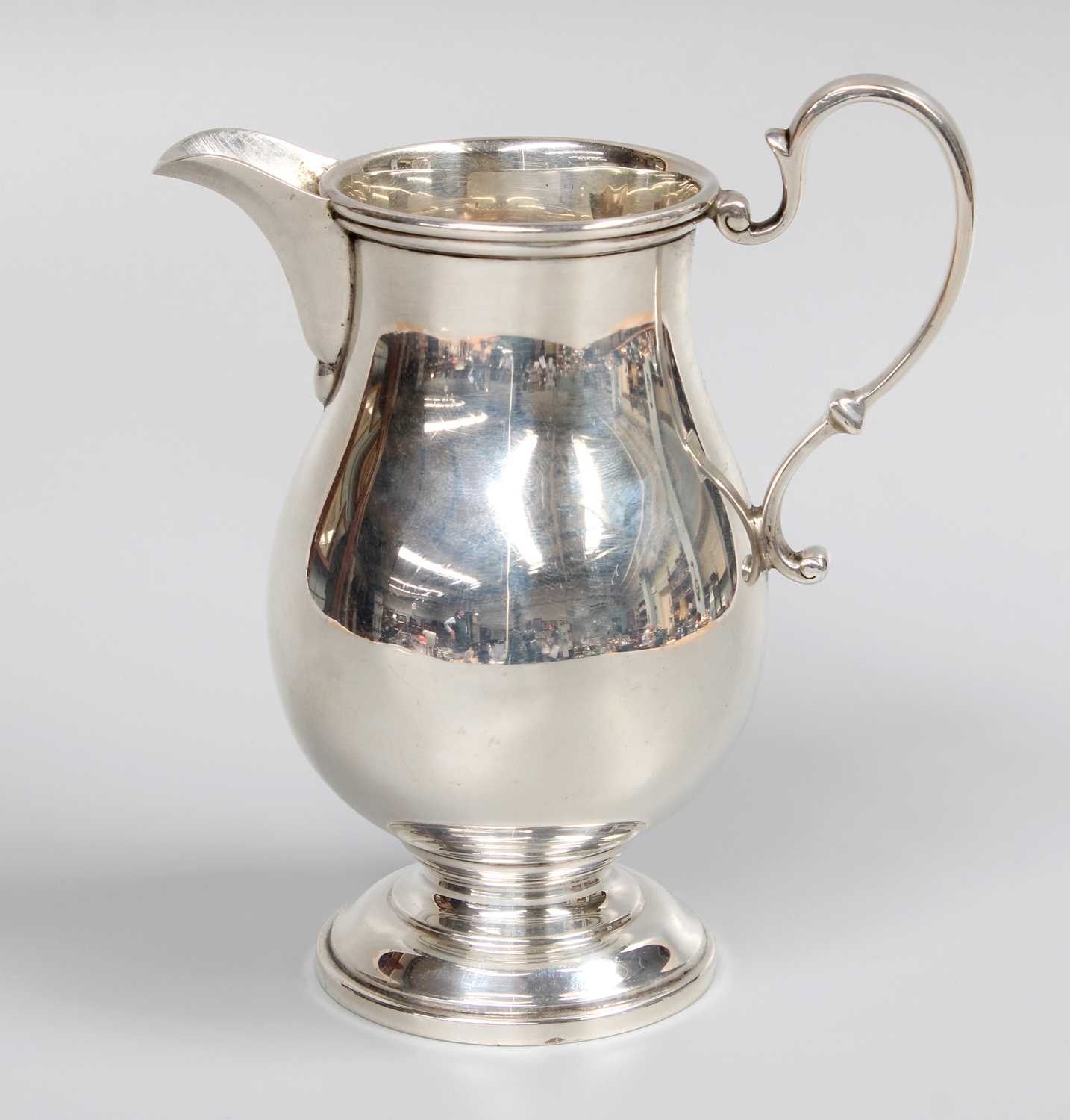 A George V Silver Cream-Jug, by James R. Ogden and Sons Ltd., Birmingham, 1935, in the George II