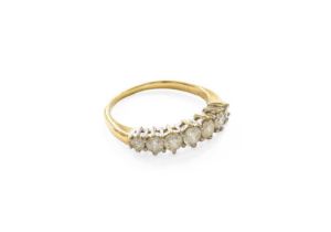 An 18 Carat Gold Diamond Seven Stone Ring, the graduated round brilliant cut diamonds in white