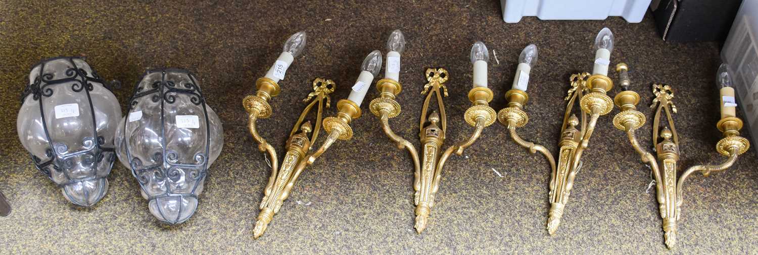 A Set of Four Gilt Metal Twin-Light Wall Sconces, together with two iron and blown glass lanterns (