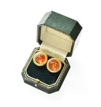 A Pair of Amber Earrings, the round cabochon amber in yellow rubbed over settings and frame, with