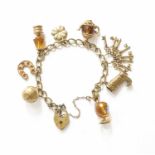 A Curb Link Bracelet, stamped '9' and '.375', suspending eight charms including a football, a