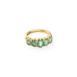 An 18 Carat Gold Emerald Five Stone Ring, the graduated oval cut emeralds in yellow claw settings,