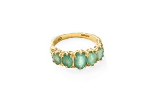 An 18 Carat Gold Emerald Five Stone Ring, the graduated oval cut emeralds in yellow claw settings,