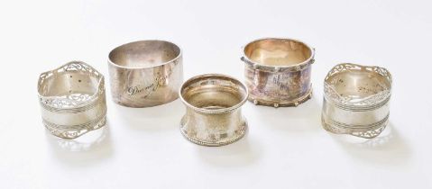 Five Various Silver Napkin-Rings, including a pair with pierced border, one engraved with
