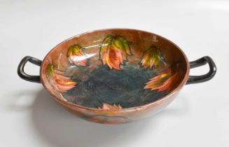 A William Moorcroft Pottery Twin Handled Dish, decorated in a flambé leaf pattern, (restored),