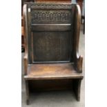 A 17th Century Style Carved Oak Single Seat Settle, of pegged construction and with panelled back