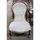 A Victorian Mahogany Spoon Back Nursing Chair, with button upholstery and scroll supports